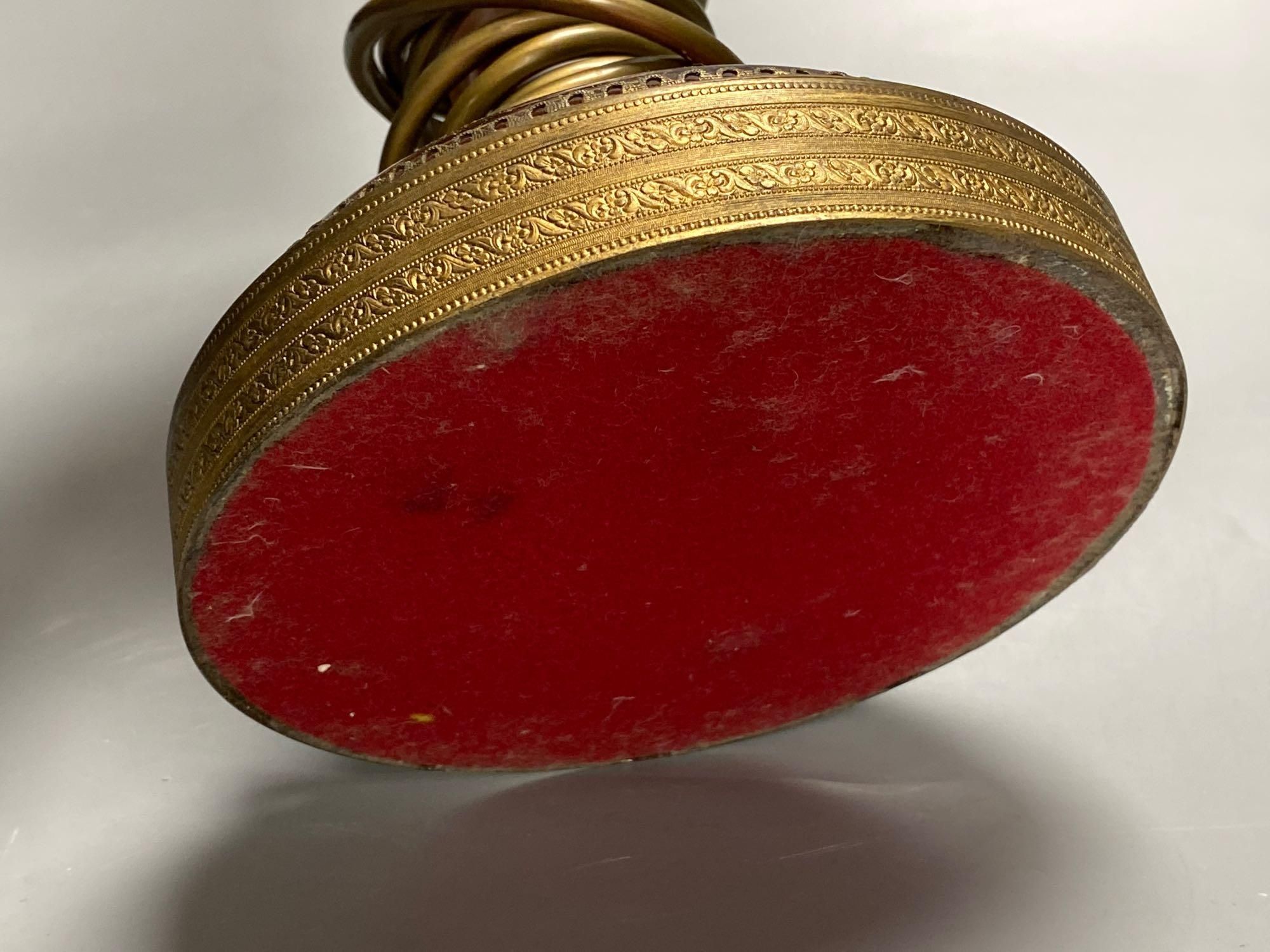 A 19th century Bohemian overlay ruby glass lamp, on engraved brass plinth, 34cm excluding light fittings